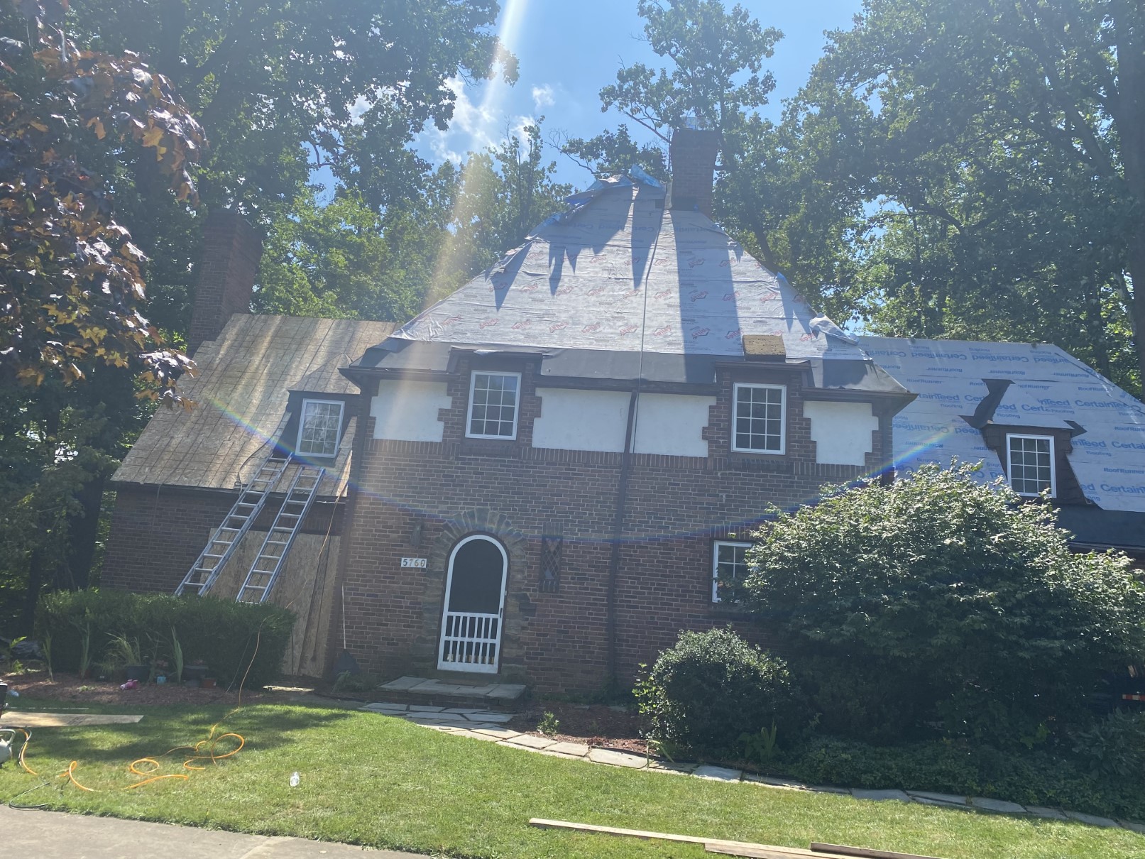 A restored brick Tudor home in Cleveland with a new roof and arched windows by Santos Lopez Construction