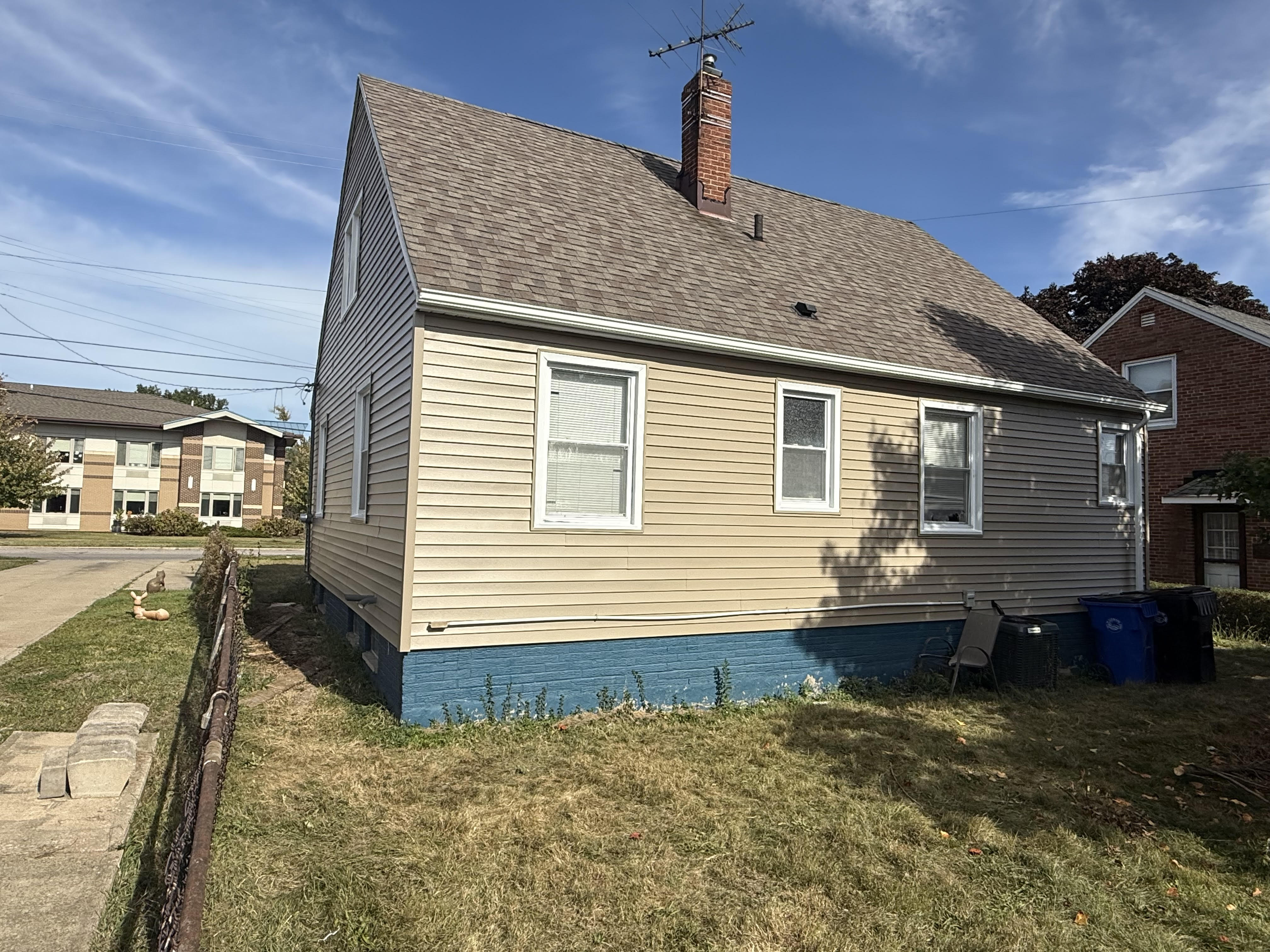 A home with fresh tan siding and a clean front elevation